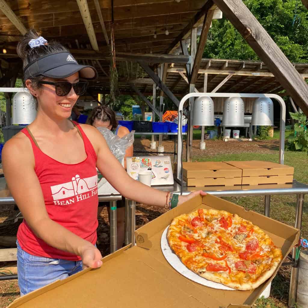 Lauren with Freshly Wood Fired Pizza on Troy Farm